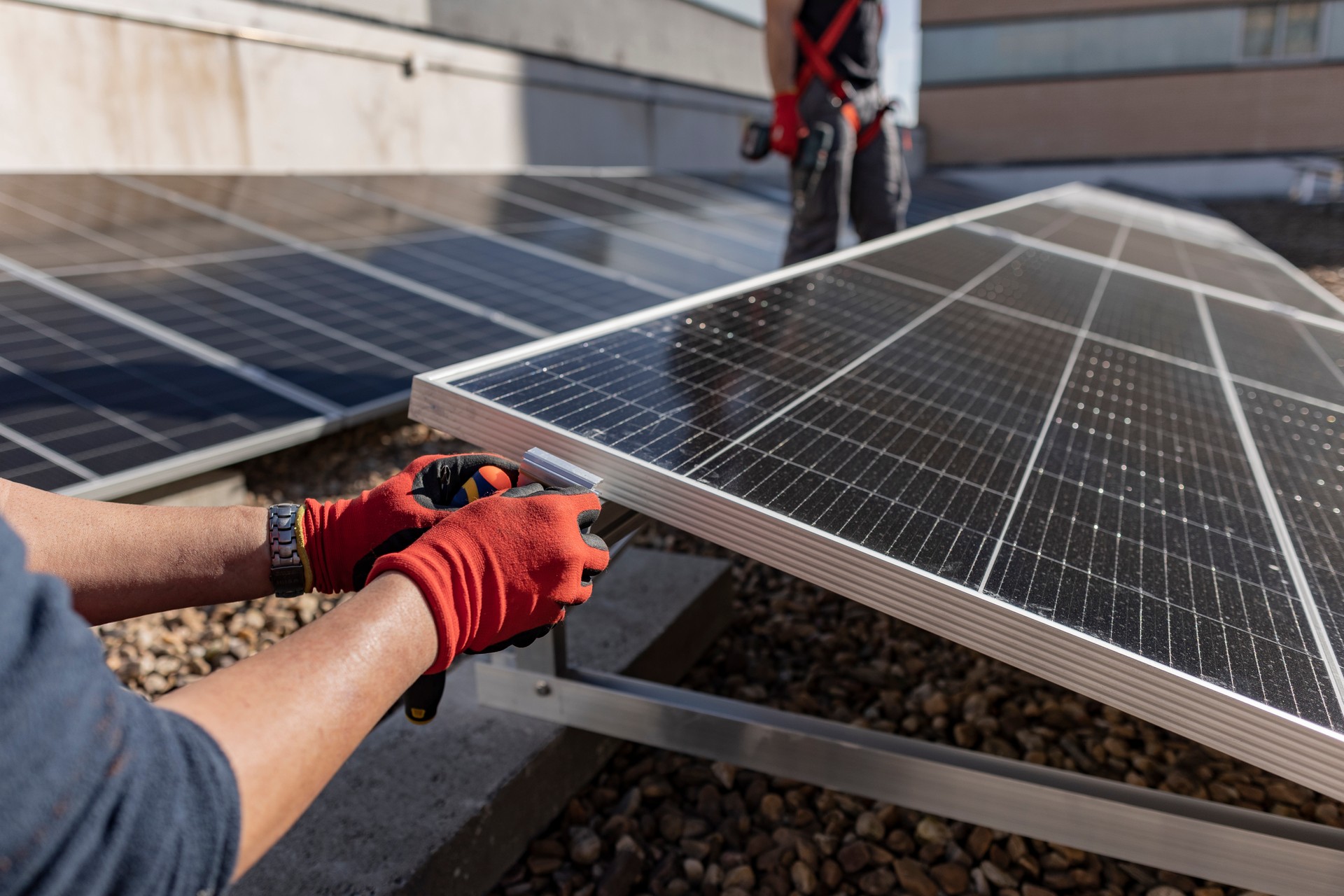 operators installing a rooftop solar panel