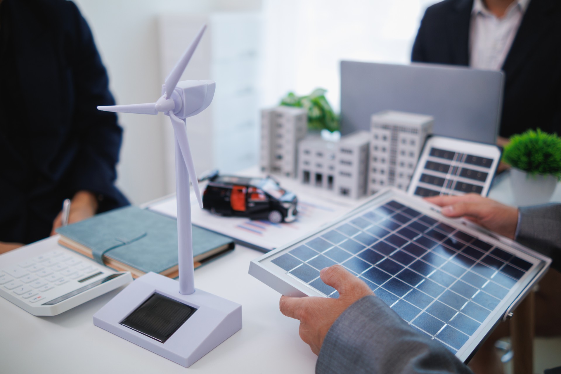 architects and investors discuss real estate projects using clean energy or solar cells within residential construction projects. Concept using clean energy in large residential construction projects.